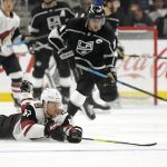 Arizona Coyotes left wing Lawson Crouse, left, dives for the puck as Los Angeles Kings center Anze Kopitar, of Slovenia, skates behind him during the second period of an NHL hockey game Thursday, Dec. 27, 2018, in Los Angeles. (AP Photo/Mark J. Terrill)