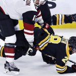 Boston Bruins center Gemel Smith (28) is dropped to the ice by Arizona Coyotes center Brad Richardson, left, during the third period of an NHL hockey game in Boston, Tuesday, Dec. 11, 2018. (AP Photo/Charles Krupa)