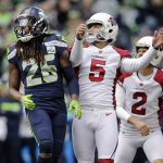 Seattle Seahawks' Shaquill Griffin (26) watches the path of Arizona Cardinals' Zane Gonzalez's (5) field goal as Cardinals holder Andy Lee (2) looks on during the first half of an NFL football game, Sunday, Dec. 30, 2018, in Seattle. (AP Photo/John Froschauer)