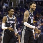 Sacramento Kings' De'Aaron Fox (5) and Willie Cauley-Stein (00) smile during the first half of an NBA basketball game against the Phoenix Suns, Tuesday, Dec. 4, 2018, in Phoenix. (AP Photo/Darryl Webb)