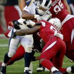 Los Angeles Rams running back John Kelly (42) is hit by Arizona Cardinals linebacker Gerald Hodges during the first half of an NFL football game, Sunday, Dec. 23, 2018, in Glendale, Ariz. (AP Photo/Rick Scuteri)