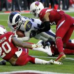 Los Angeles Rams running back C.J. Anderson (35) scores a touchdown as Arizona Cardinals outside linebacker Deone Bucannon (20) and Arizona Cardinals defensive back David Amerson defend during the first half of an NFL football game, Sunday, Dec. 23, 2018, in Glendale, Ariz. (AP Photo/Rick Scuteri)
