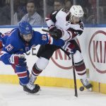 New York Rangers center Mika Zibanejad (93) fights for the puck against Arizona Coyotes right wing Mario Kempe (29) during the second period of an NHL hockey game, Friday, Dec. 14, 2018, at Madison Square Garden in New York. (AP Photo/Mary Altaffer)