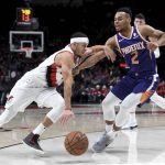 Portland Trail Blazers guard Seth Curry, left, drives to the basket on Phoenix Suns guard Elie Okobo during the second half of an NBA basketball game in Portland, Ore., Thursday, Dec. 6, 2018. The Blazers won 108-86. (AP Photo/Steve Dykes)