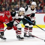 Carolina Hurricanes' Teuvo Teravainen (86) tips the puck away from Arizona Coyotes' Clayton Keller (9) with Coyotes' Nick Cousins (25) looking on during the first period of an NHL hockey game, Sunday, Dec. 16, 2018, in Raleigh, N.C. (AP Photo/Karl B DeBlaker)