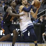 Minnesota Timberwolves guard Tyus Jones (1) drives to the basket past the defense of Phoenix Suns' Jawun Evans during the first half of an NBA basketball game, Saturday, Dec. 15, 2018, in Phoenix. (AP Photo/Ralph Freso)