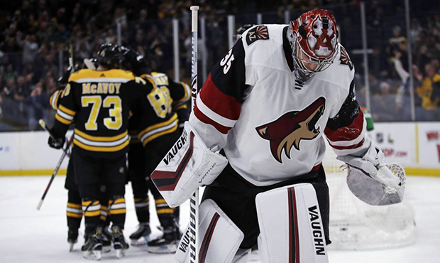 Arizona Coyotes goaltender Darcy Kuemper (35) skates away as Boston Bruins left wing Brad Marchand ...