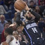 Orlando Magic guard D.J. Augustin (14) puts up a 3-point shot after being fouled by Phoenix Suns forward Mikal Bridges, left, during the second half of an NBA basketball game Wednesday, Dec. 26, 2018, in Orlando, Fla. (AP Photo/Phelan M. Ebenhack)