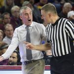 Arizona State coach Bobby Hurley, left, argues a call with an official during the first half of the team's NCAA college basketball game against Princeton, Saturday, Dec. 29, 2018, in Tempe, Ariz. Princeton defeated No. 18 Arizona State 67-66. (AP Photo/Ralph Freso)
