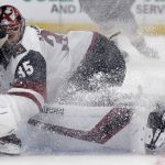 Arizona Coyotes goaltender Darcy Kuemper (35) is dusted up with ice as Boston Bruins right wing David Pastrnak, left, collides and pokes the puck in for a goal during the second period of an NHL hockey game in Boston, Tuesday, Dec. 11, 2018. (AP Photo/Charles Krupa)