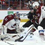 Arizona Coyotes right wing Christian Fischer (36) gets ready to send the puck past Colorado Avalanche goaltender Philipp Grubauer (31) for a goal as Avalanche defenseman Patrik Nemeth looks on during the second period of an NHL hockey game Saturday, Dec. 22, 2018, in Glendale, Ariz. (AP Photo/Ross D. Franklin)