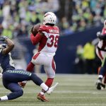 Arizona Cardinals' David Amerson (38) intercepts the ball in front of Seattle Seahawks' David Moore during the first half of an NFL football game, Sunday, Dec. 30, 2018, in Seattle. (AP Photo/John Froschauer)
