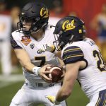 California quarterback Chase Garbers (7) hands the ball off to running back Patrick Laird (28) during the first half of the Cheez-It Bowl NCAA college football game against TCU on Wednesday, Dec. 26, 2018, in Phoenix. (AP Photo/Ross D. Franklin)