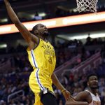 Golden State Warriors forward Kevin Durant (35) dunks over Phoenix Suns center Deandre Ayton during the first half during an NBA basketball game Monday, Dec. 31, 2018, in Phoenix. (AP Photo/Rick Scuteri)