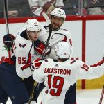 Washington Capitals left wing Andre Burakovsky (65) celebrates his goal against the Arizona Coyotes with center Nicklas Backstrom (19) and left wing Alex Ovechkin (8) during the third period of an NHL hockey game Thursday, Dec. 6, 2018, in Glendale, Ariz. The Capitals won 4-2. (AP Photo/Ross D. Franklin)