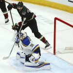 
              St. Louis Blues goaltender Chad Johnson (31) gives up a goal to Arizona Coyotes' Jakob Chychrun as Coyotes center Alex Galchenyuk (17) looks on during the first period of an NHL hockey game, Saturday, Dec. 1, 2018, in Glendale, Ariz. (AP Photo/Ross D. Franklin)
            