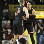Princeton guard Devin Cannady, right, and teammate Drew Friberg (5) celebrate a victory over Arizona State as Arizona State's Luguentz Dort, bottom, reacts to the loss in an NCAA college basketball game, Saturday, Dec. 29, 2018, in Tempe, Ariz. (AP Photo/Ralph Freso)