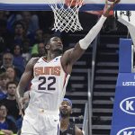 Phoenix Suns center Deandre Ayton (22) goes up for a shot in front of Orlando Magic guard Terrence Ross (31) during the second half of an NBA basketball game Wednesday, Dec. 26, 2018, in Orlando, Fla. (AP Photo/Phelan M. Ebenhack)
