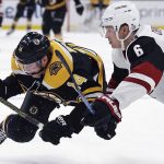 Boston Bruins right wing Chris Wagner (14) goes airborne while chasing the puck against Arizona Coyotes defenseman Jakob Chychrun (6) during the second period of an NHL hockey game in Boston, Tuesday, Dec. 11, 2018. (AP Photo/Charles Krupa)