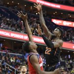 Phoenix Suns center Deandre Ayton (22) shoots against Washington Wizards center Thomas Bryant, left, during the first half of an NBA basketball game, Saturday, Dec. 22, 2018, in Washington. (AP Photo/Nick Wass)
