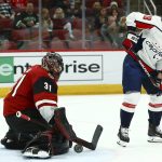 Arizona Coyotes goaltender Adin Hill (31) makes a save on a deflection from Washington Capitals center Chandler Stephenson (18) during the first period of an NHL hockey game Thursday, Dec. 6, 2018, in Glendale, Ariz. (AP Photo/Ross D. Franklin)