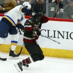 Arizona Coyotes right wing Michael Grabner, right, falls to the ice due to injury as St. Louis Blues left wing Sammy Blais, left, skates with the puck during the first period of an NHL hockey game, Saturday, Dec. 1, 2018, in Glendale, Ariz. (AP Photo/Ross D. Franklin)