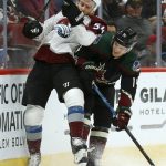 Arizona Coyotes right wing Richard Panik (14) checks Colorado Avalanche defenseman Anton Lindholm (54) into the boards during the second period of an NHL hockey game Saturday, Dec. 22, 2018, in Glendale, Ariz. (AP Photo/Ross D. Franklin)