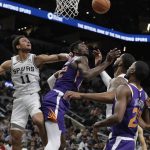 Phoenix Suns center Deandre Ayton (22) loses control of the ball as he tries to score past San Antonio Spurs guard Bryn Forbes (11) during the first half of an NBA basketball game, Tuesday, Dec. 11, 2018, in San Antonio. (AP Photo/Eric Gay)