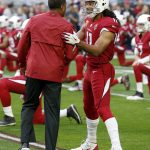 Arizona Cardinals wide receiver Larry Fitzgerald (11) greets head coach Steve Wilks prior to an NFL football game against the Los Angeles Rams, Sunday, Dec. 23, 2018, in Glendale, Ariz. (AP Photo/Ross D. Franklin)