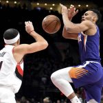 Portland Trail Blazers guard Seth Curry, left, knocks the ball away from Phoenix Suns guard Elie Okobo, right, during the first half of an NBA basketball in Portland, Ore., Thursday, Dec. 6, 2018. (AP Photo/Steve Dykes)