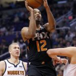 Phoenix Suns' T.J. Warren (12) shoots as Denver Nuggets forward Mason Plumlee (24) looks on during the second half of an NBA basketball game, Saturday, Dec. 29, 2018, in Phoenix. (AP Photo/Matt York)