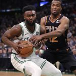 Boston Celtics guard Jaylen Brown, left, drives against Phoenix Suns forward T.J. Warren, right, during the first quarter of a basketball game in Boston, Wednesday, Dec. 19, 2018. (AP Photo/Charles Krupa)