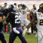 TCU place-kicker Jonathan Song (46) celebrates his game-winning field goal with holder Adam Nunez (29) as California's Traveon Beck (22) looks the other way during overtime of the Cheez-It Bowl NCAA college football game Wednesday, Dec. 26, 2018, in Phoenix. TCU defeated California 10-7. (AP Photo/Ross D. Franklin)