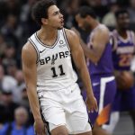 San Antonio Spurs guard Bryn Forbes (11) reacts after scoring against the Phoenix Suns during the first half of an NBA basketball game, Tuesday, Dec. 11, 2018, in San Antonio. (AP Photo/Eric Gay)