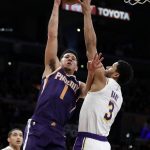 Phoenix Suns' Devin Booker (1) shoots over Los Angeles Lakers' Josh Hart (3) during the first half of an NBA basketball game Sunday, Dec. 2, 2018, in Los Angeles. (AP Photo/Marcio Jose Sanchez)