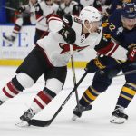Buffalo Sabres forward Johan Larsson (22) and Arizona Coyotes forward Michael Bunting (58) battle for position during the second period of an NHL hockey game, Thursday, Dec. 13, 2018, in Buffalo N.Y. (AP Photo/Jeffrey T. Barnes)