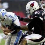 Detroit Lions quarterback Matthew Stafford (9) is hit by Arizona Cardinals defensive tackle Robert Nkemdiche (90) during the first half of NFL football game, Sunday, Dec. 9, 2018, in Glendale, Ariz. (AP Photo/Ross D. Franklin)