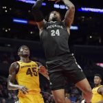 
              Nevada forward Jordan Caroline, right, shoots as Arizona State forward Zylan Cheatham defends during the first half of an NCAA college basketball game at the Basketball Hall of Fame Classic Friday, Dec. 7, 2018, in Los Angeles. (AP Photo/Mark J. Terrill)
            