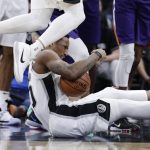 San Antonio Spurs guard DeMar DeRozan (10) falls to the floor after he was fouled during the first half of an NBA basketball game against the Phoenix Suns, Tuesday, Dec. 11, 2018, in San Antonio. (AP Photo/Eric Gay)