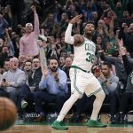 Boston Celtics guard Marcus Smart (36), and fans, celebrate after hitting a 3-point shot to end the second quarter of a basketball game against the Phoenix Suns in Boston, Wednesday, Dec. 19, 2018. (AP Photo/Charles Krupa)