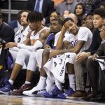 Players on the Phoenix Suns bench watch the action against the Sacramento Kings during the second half of an NBA basketball game, Tuesday, Dec. 4, 2018, in Phoenix. (AP Photo/Darryl Webb)