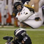 California quarterback Chase Garbers, top, gets upended by TCU safety Vernon Scott (26) during the first half of the Cheez-It Bowl NCAA college football game Wednesday, Dec. 26, 2018, in Phoenix. (AP Photo/Ross D. Franklin)