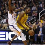 Golden State Warriors forward Kevin Durant (35) is fouled by Phoenix Suns guard Elie Okobo during the first half of an NBA basketball game Monday, Dec. 31, 2018, in Phoenix. (AP Photo/Rick Scuteri)