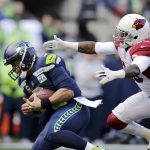 Arizona Cardinals' Deone Bucannon, right, sacks Seattle Seahawks quarterback Russell Wilson during the first half of an NFL football game, Sunday, Dec. 30, 2018, in Seattle. (AP Photo/John Froschauer)