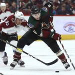 Arizona Coyotes center Nick Schmaltz (8) tries to keep the puck away from Colorado Avalanche left wing Matt Nieto (83) during the second period of an NHL hockey game Saturday, Dec. 22, 2018, in Glendale, Ariz. (AP Photo/Ross D. Franklin)