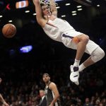 Phoenix Suns' Devin Booker (1) dunks in front of Brooklyn Nets' Jared Dudley during the first half of an NBA basketball game Sunday, Dec. 23, 2018, in New York. (AP Photo/Frank Franklin II)