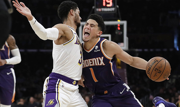 Phoenix Suns' Devin Booker (1) is defended by Los Angeles Lakers' Josh Hart (3) during the first ha...