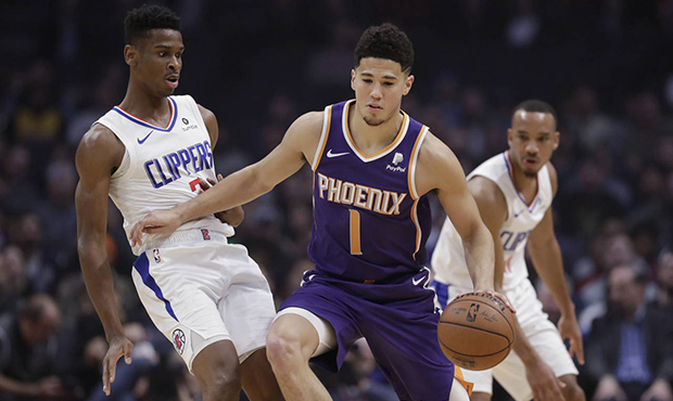 Phoenix Suns' Devin Booker (1) is defended by Los Angeles Clippers' Shai Gilgeous-Alexander during ...
