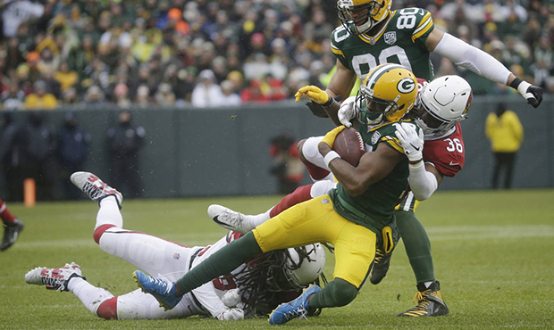 Green Bay Packers wide receiver Davante Adams is hit by Arizona Cardinals strong safety Budda Baker...