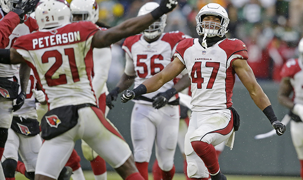 Arizona Cardinals players celebrate a win after a last minute missed field goal by the Green Bay Pa...